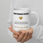 White ceramic Bloom Through Pressure affirmation mug, 20 oz, shown with the handle on the right